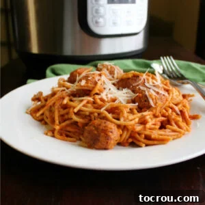 Instant Pot Magic: Creamy One-Pot Meatball Spaghetti 6 pile of spaghetti and meatballs on plate in front of instant pot.