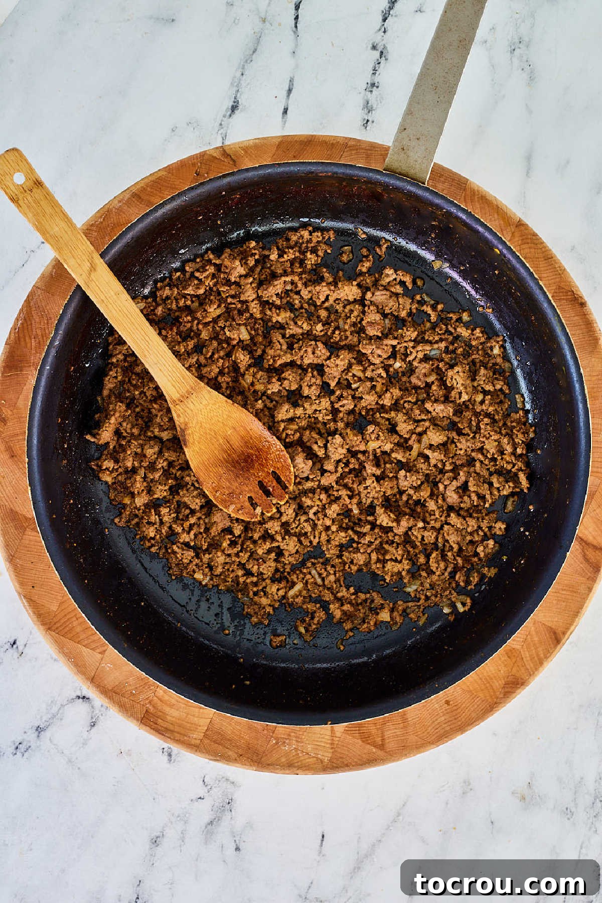 Cooked crumbled maidrite filling in skillet, ready to be made into sandwiches.