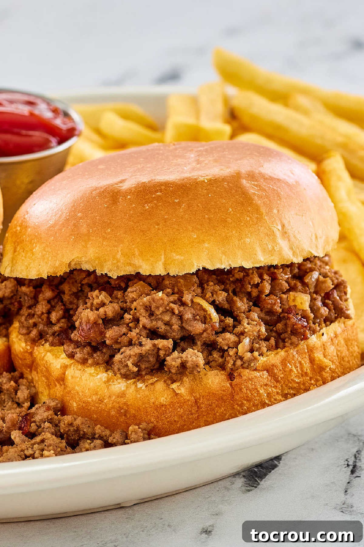 Maid rite sandwich with crumbled ground beef filling on hamburger bun.
