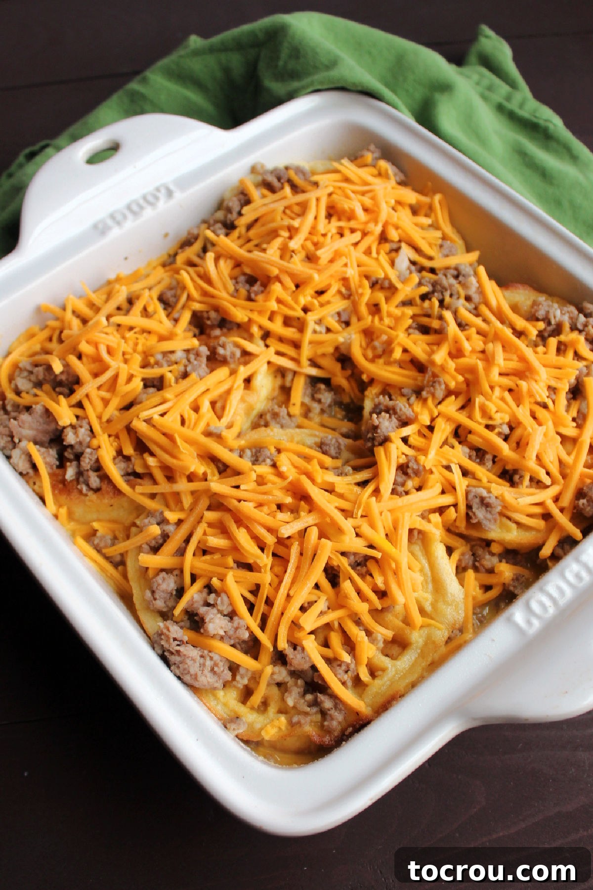 Casserole Ready for Baking The assembled casserole with egg-soaked waffles, sausage, and cheese in a baking dish, ready to be placed in the oven.