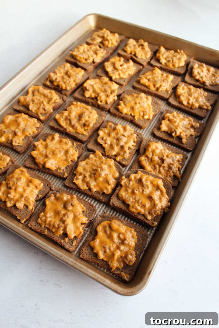 Whip up a batch of party ryes for a fun pizza inspired appetizer later. Once batch makes a ton of flatbreads and they freeze great to bake later. Party ryes arranged neatly on a baking sheet pan, ready to be placed into the oven.