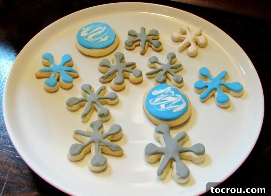 plate of cookies shaped like jacks toys and balls.