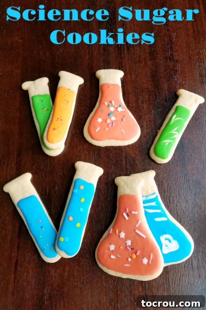 test tube and erlenmeyer flask cut out cookies decorated with colorful royal icing and sprinkles.