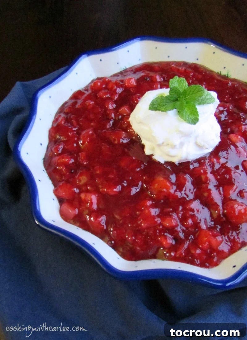 Tropical Cherry Fluff Salad 4 Exquisite Polish pottery bowl filled with cherry and pineapple jello salad, elegantly topped with whipped cream and a sprig of fresh mint