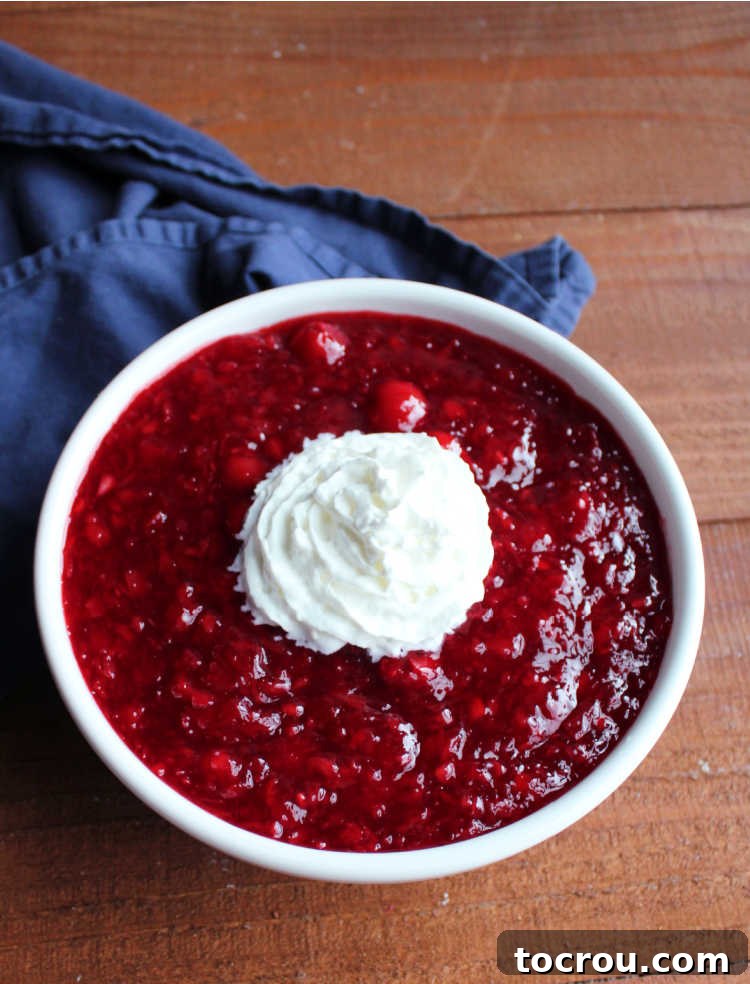Tropical Cherry Fluff Salad 6 Large serving bowl of cherry pineapple jello salad, beautifully topped with swirls of whipped cream, ready to be enjoyed