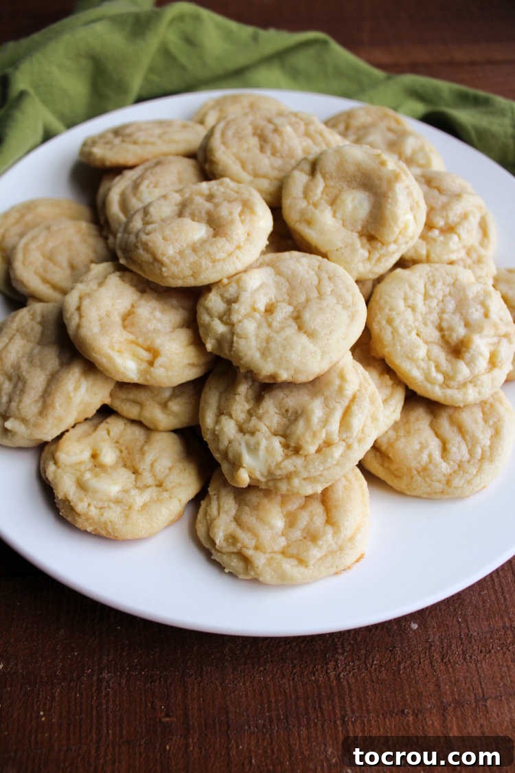 A plate piled high with chewy white hot chocolate mix cookies, showcasing their inviting texture.