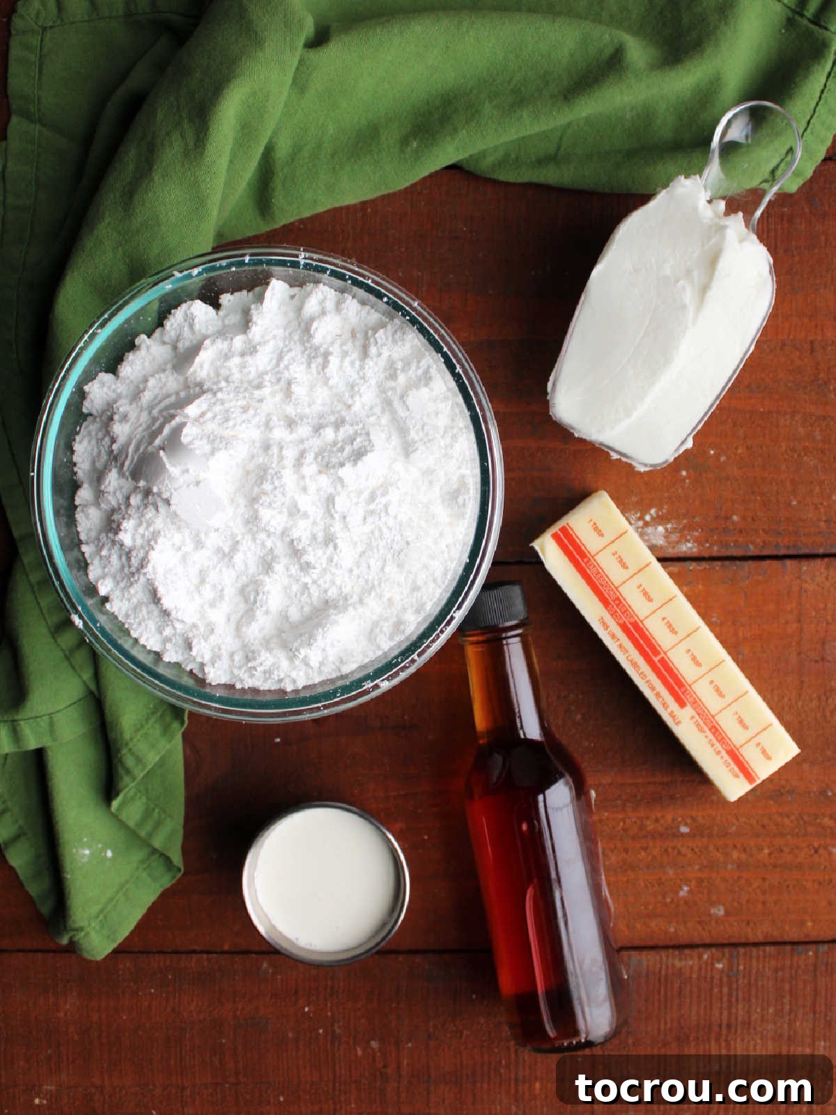 Ingredients for buttercream frosting, including butter, shortening, vanilla, cream, and powdered sugar, ready to be combined.