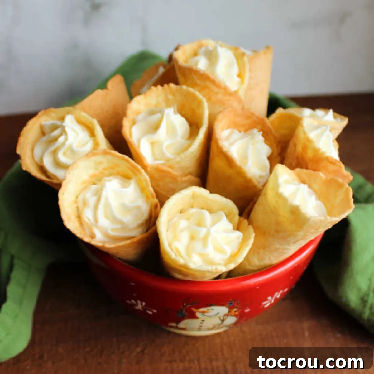 A bowl of Russian buttercream filled krumkake horns, a traditional Scandinavian cookie.