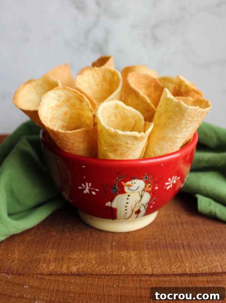 A bowl filled with crunchy krumkake horns, ready to be enjoyed or filled.