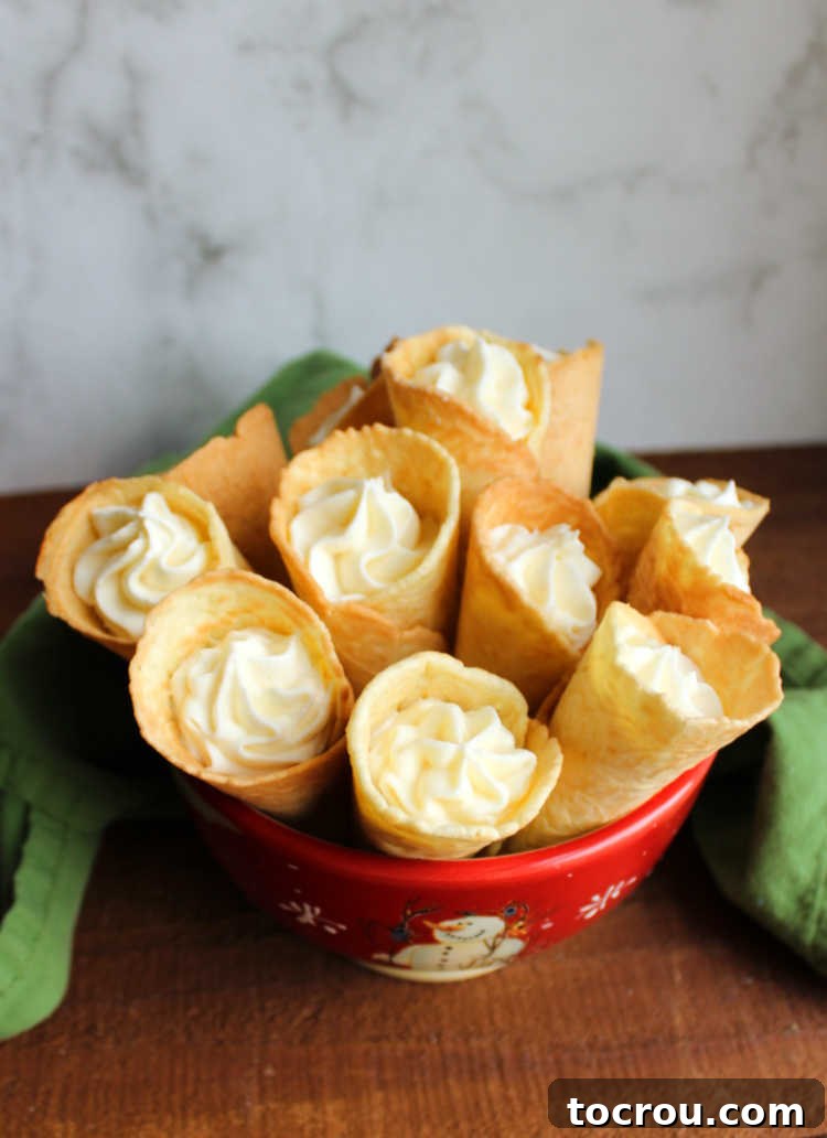 A bowl of krumkake cookies filled with a sweet, creamy frosting.