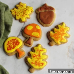 Cinnamon Brown Sugar Cut-Out Cookies Delicate cinnamon brown sugar cookies, cut into festive autumn shapes like leaves, mushrooms, and acorns, beautifully decorated with intricate royal icing designs.