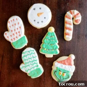 Classic Decorated Sugar Cookies Sugar cookies rolled and cut in Christmas shapes decorated with royal icing, showcasing festive designs.
