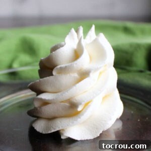 swirl of white classic American buttercream on plate.