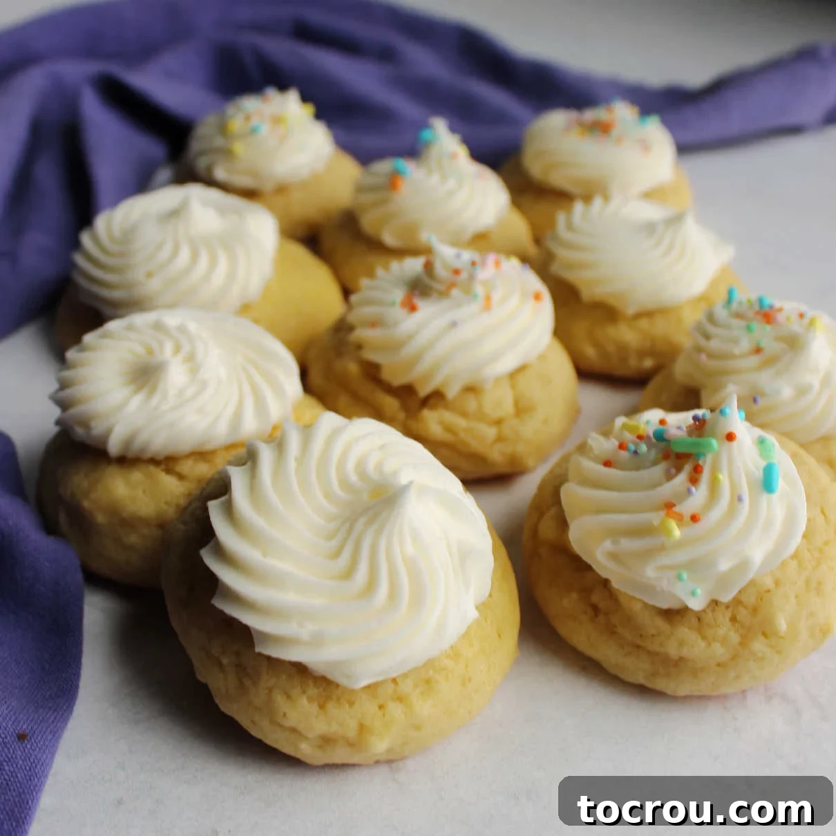 The Ultimate Soft Sour Cream Drop Cookies with Creamy Buttercream Frosting Soft and thick sour cream cookies topped with swirls of delicious buttercream frosting, showcasing their inviting texture.