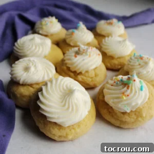 Soft and thick sour cream cookies topped with swirls of buttercream on top.