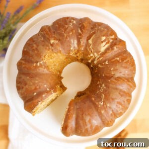 Looking down at a beautiful Chai Spiced Bundt Cake with Espresso Glaze, perfectly presented on a serving platter, ready for guests.