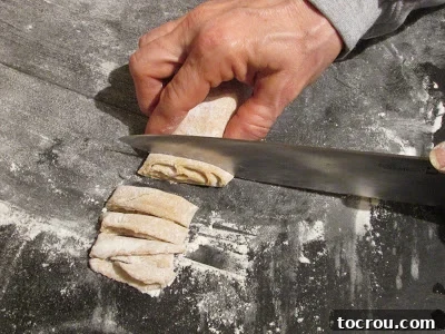 cutting homemade egg noodles