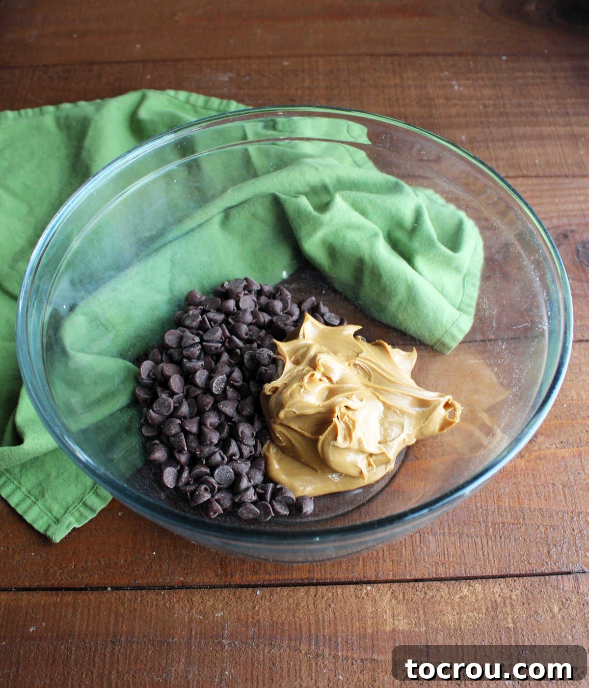 Chocolate chips and peanut butter in bowl ready to be melted and made into original puppy chow.