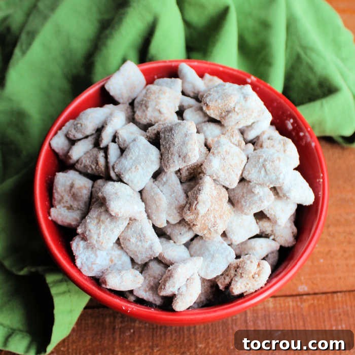 bowl of powder sugar coated muddy buddies ready to eat.