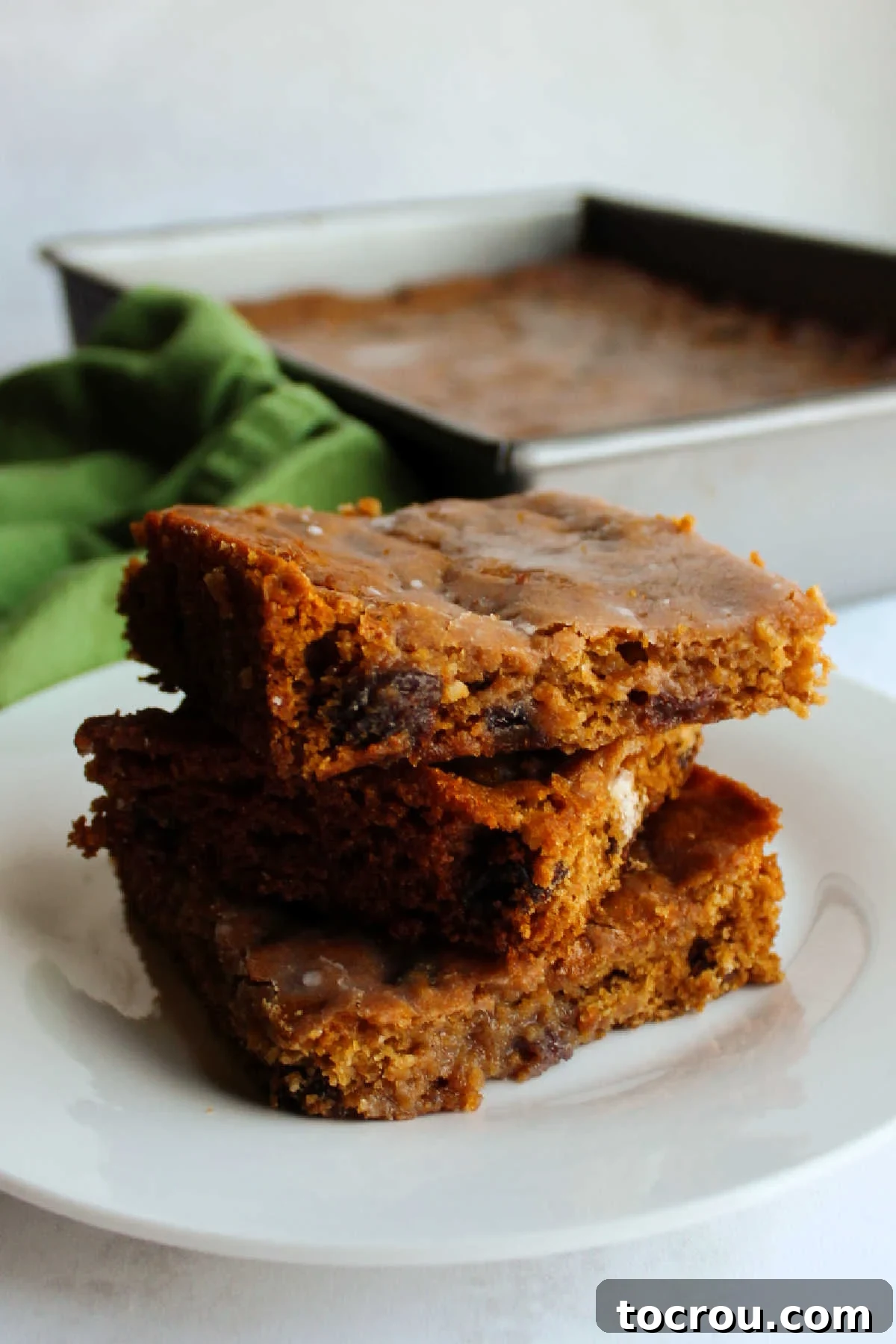 Stacked Poor Man's Cake A neat stack of Poor Man's Cake slices arranged in a baking pan, showcasing the cake's texture and inviting appearance.