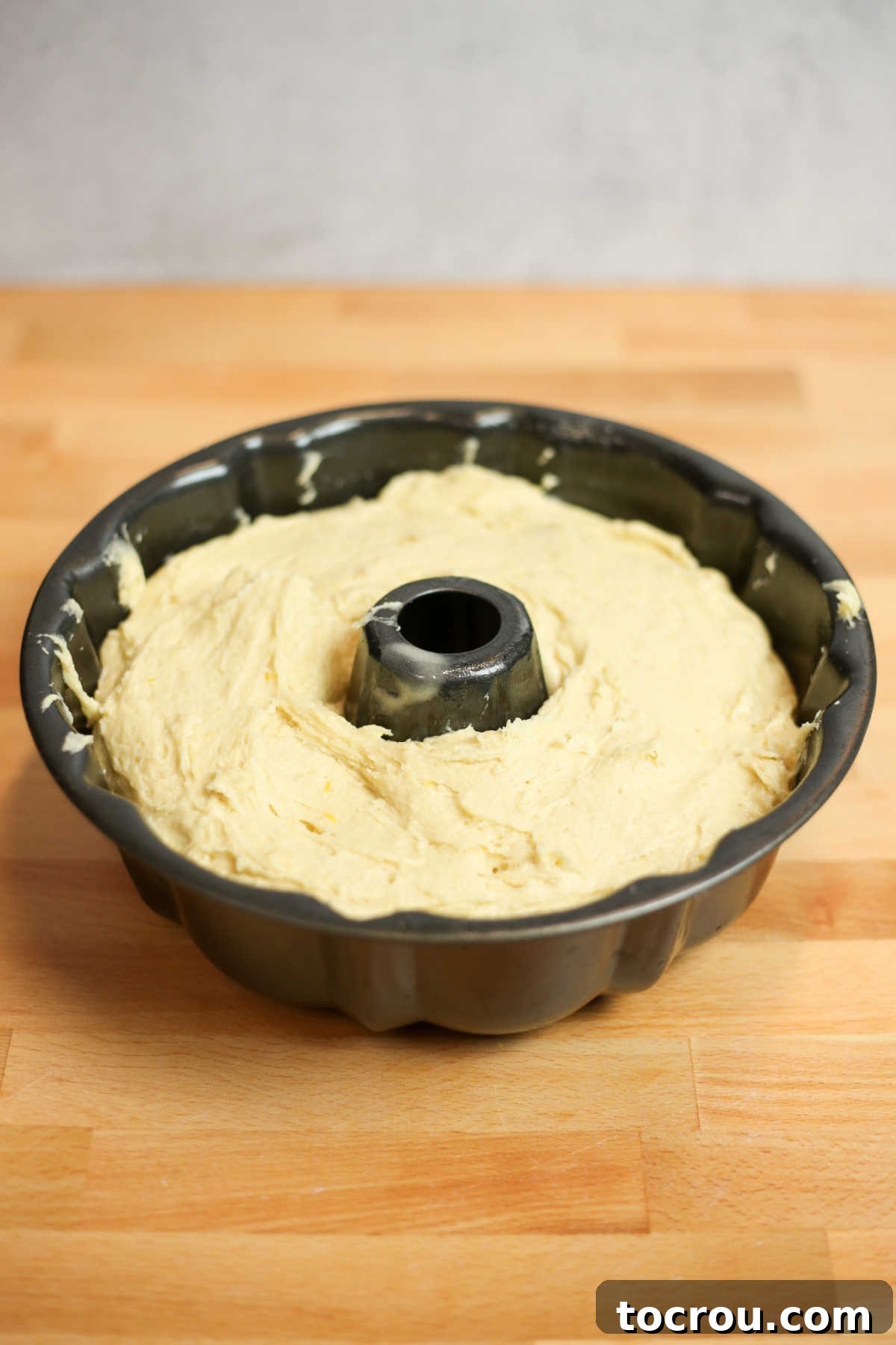 Sun-Kissed Lemon Bundt with Ginger Drizzle 4 Smooth lemon cake batter in a decorative Bundt pan, ready to be baked.