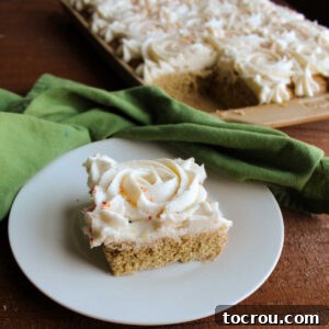 A delicious piece of pumpkin spice cookie bar adorned with a piped rosette of marshmallow buttercream on top.