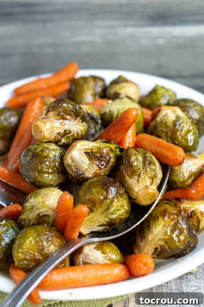 Serving Dish of Roasted Veggies A serving dish generously filled with beautifully roasted Brussels sprouts and baby carrots, ready for the table.