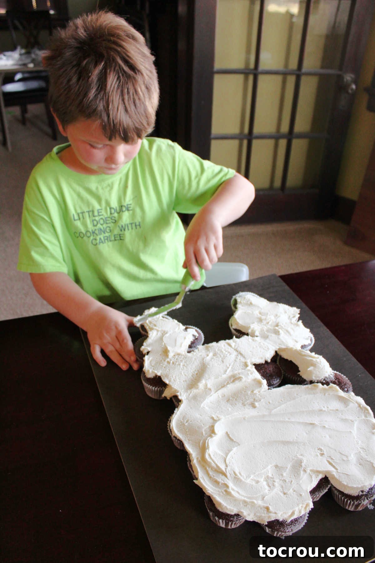 More white frosting spread smoothly over the tooth-shaped cupcakes, creating a seamless surface.