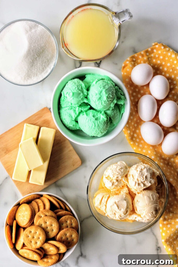 Lime sherbet bar ingredients including crackers, butter, sherbet, ice cream, eggs, butter and more ready to be made into bars.