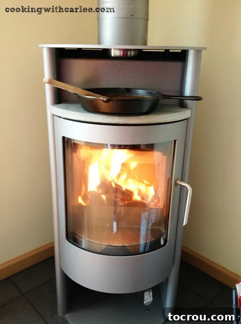 Wood Stove Apple Butter cast iron pan filled with apple butter being cooked on wood stove