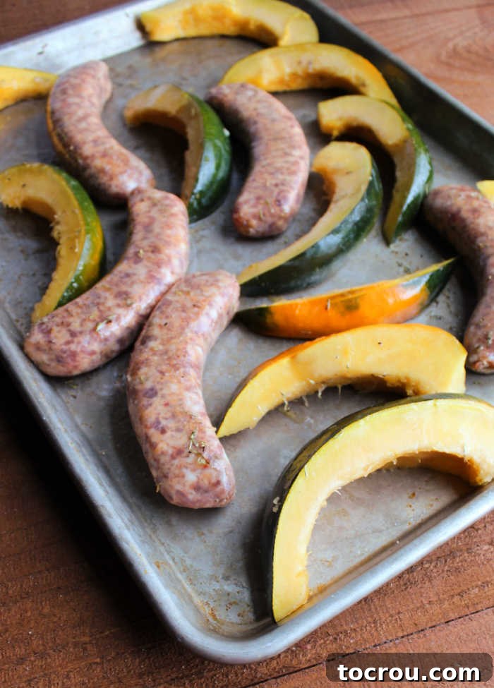 A bowl brimming with fresh kale, meticulously prepared and ready to be introduced to a sheet pan alongside partially cooked sausages and squash, promising a vibrant addition to the meal.