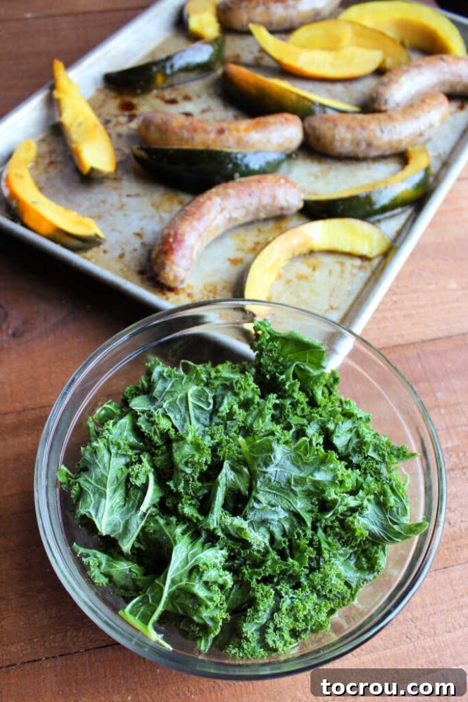 Another view of a bowl of freshly prepared kale, its leaves glistening slightly, awaiting its turn to join the other ingredients on the sheet pan, adding a final touch of color and nutrition.