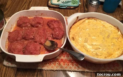 Close-up picture of BBQ ham balls served with creamy scalloped potatoes, a classic side dish.