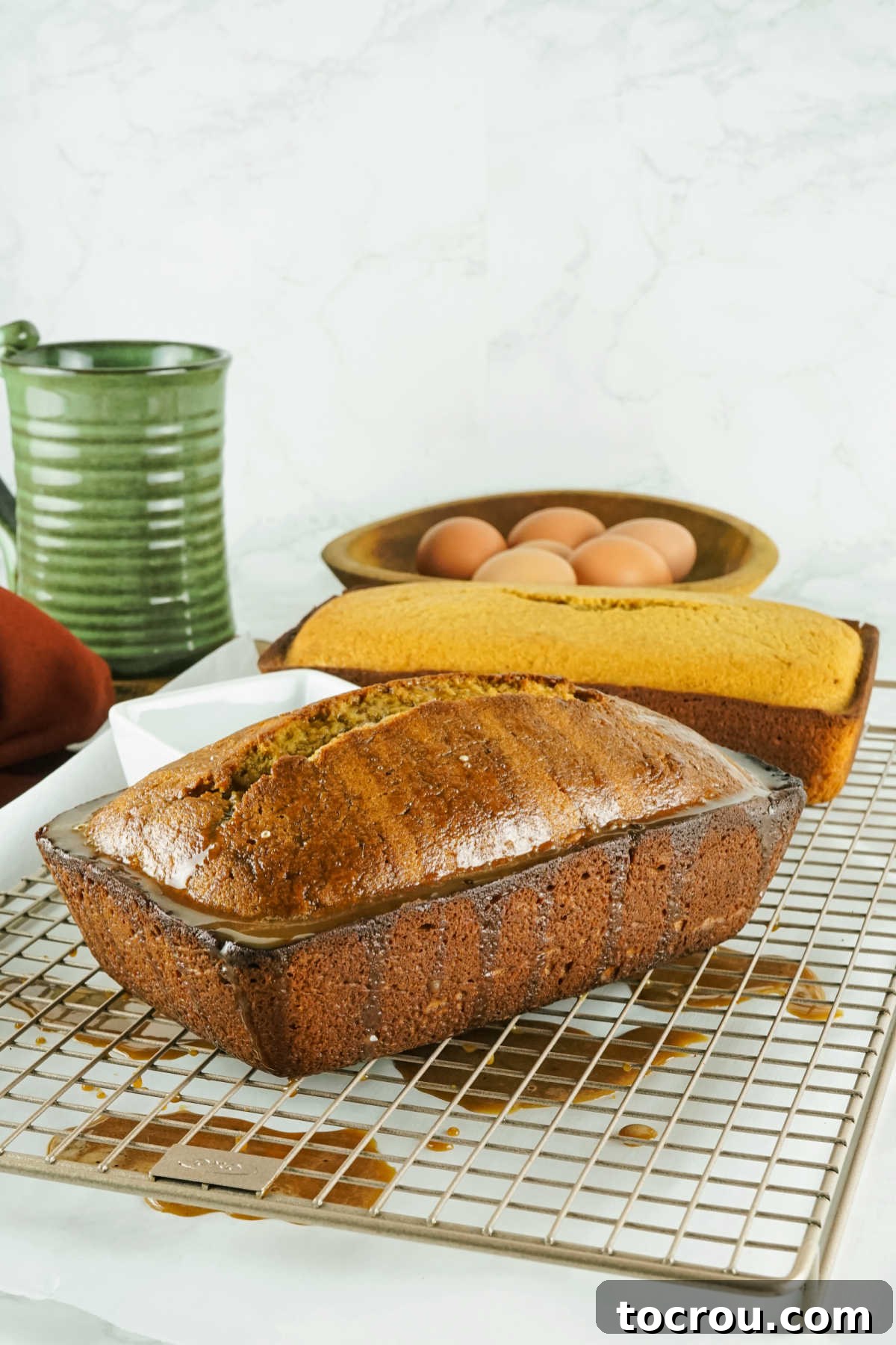Espresso Pound Cake 5 Freshly baked coffee pound cake loaf on wire rack with coffee flavored glaze drizzled over the top.