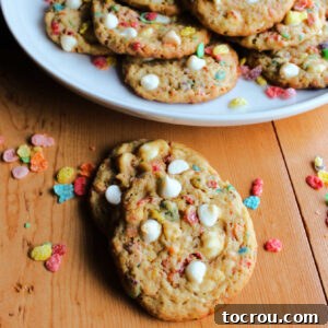 Colorful Fruity Pebbles cookies with white chocolate chips, presented beautifully on a plate.