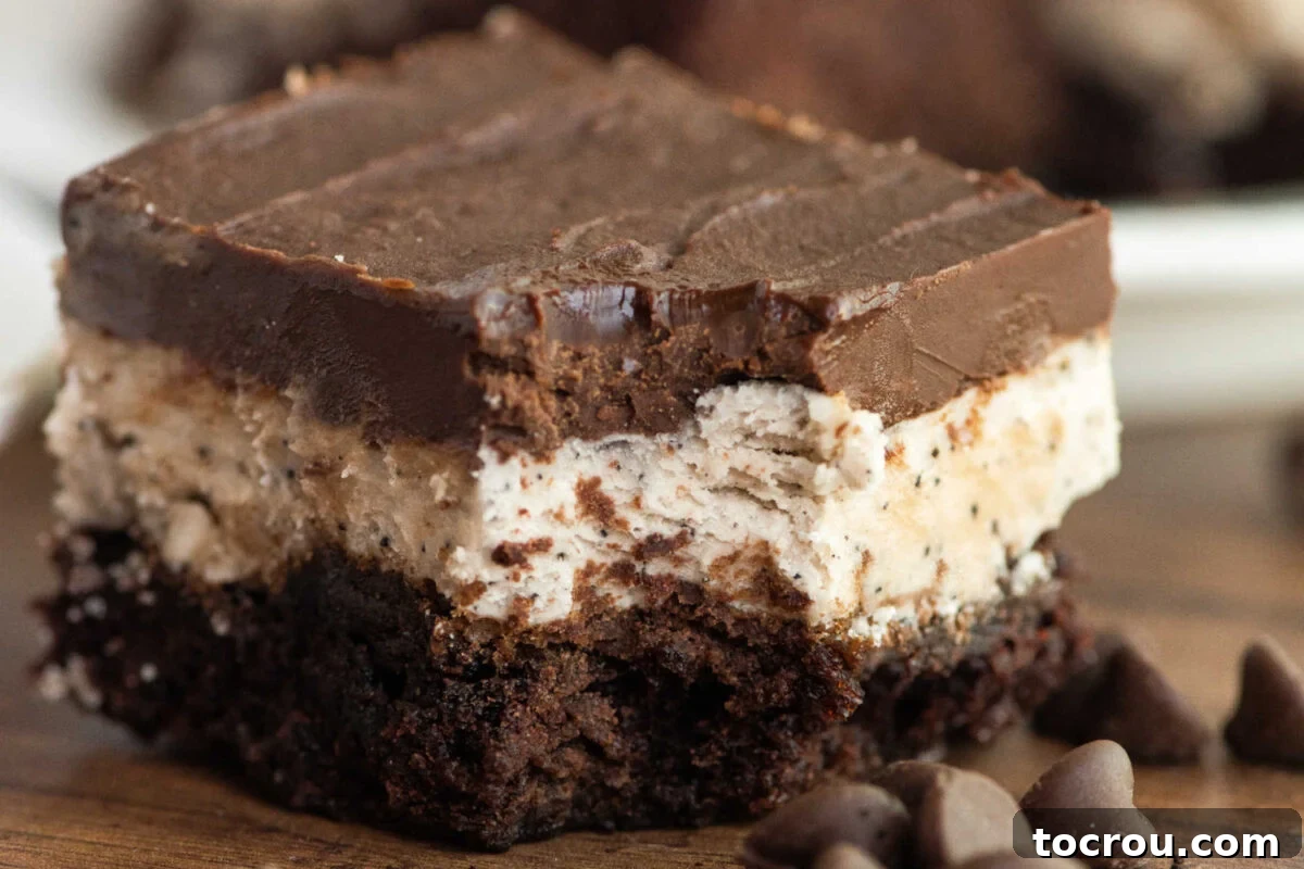 Close up of a brownie topped with coffee buttercream and rich chocolate frosting, ready to eat. 