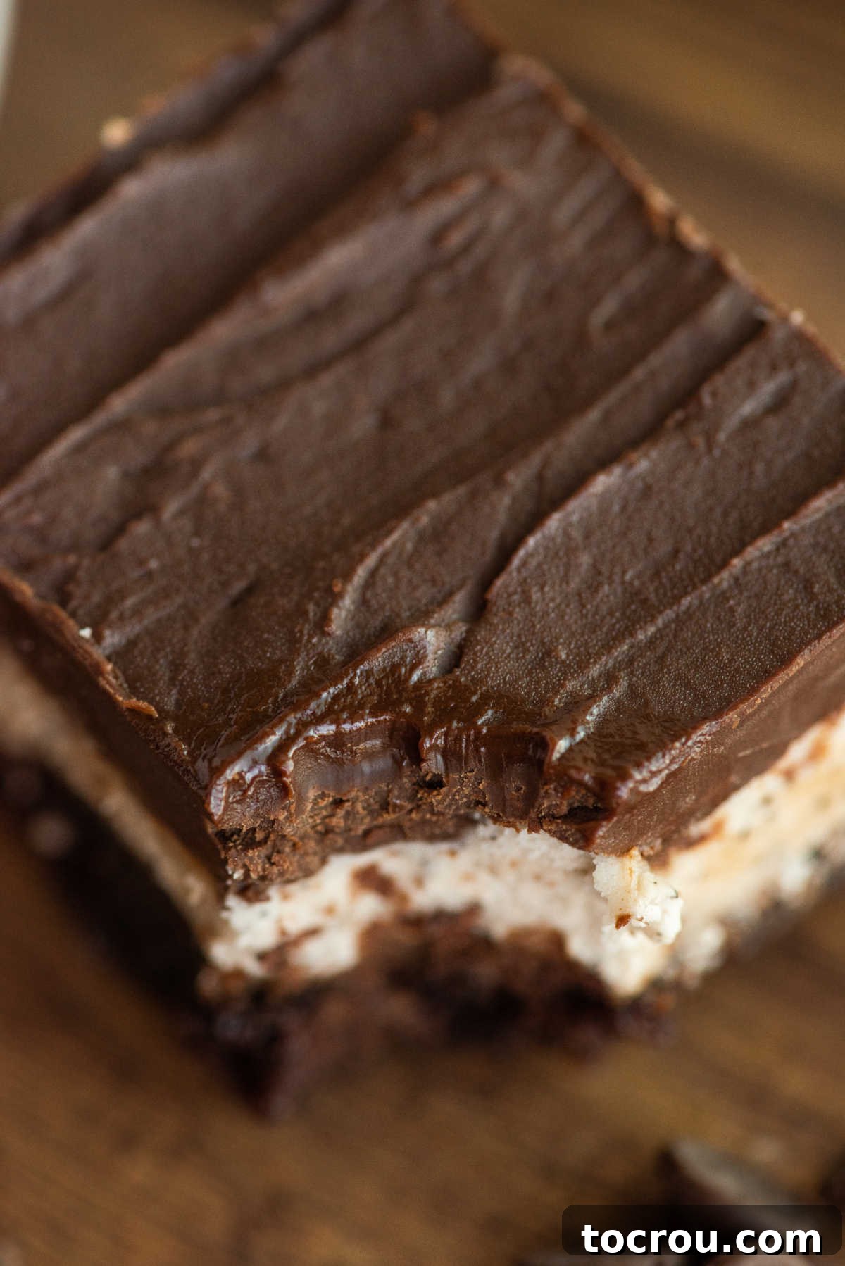Looking down on fudgy ganache topping over creamy coffee buttercream and brownie. 