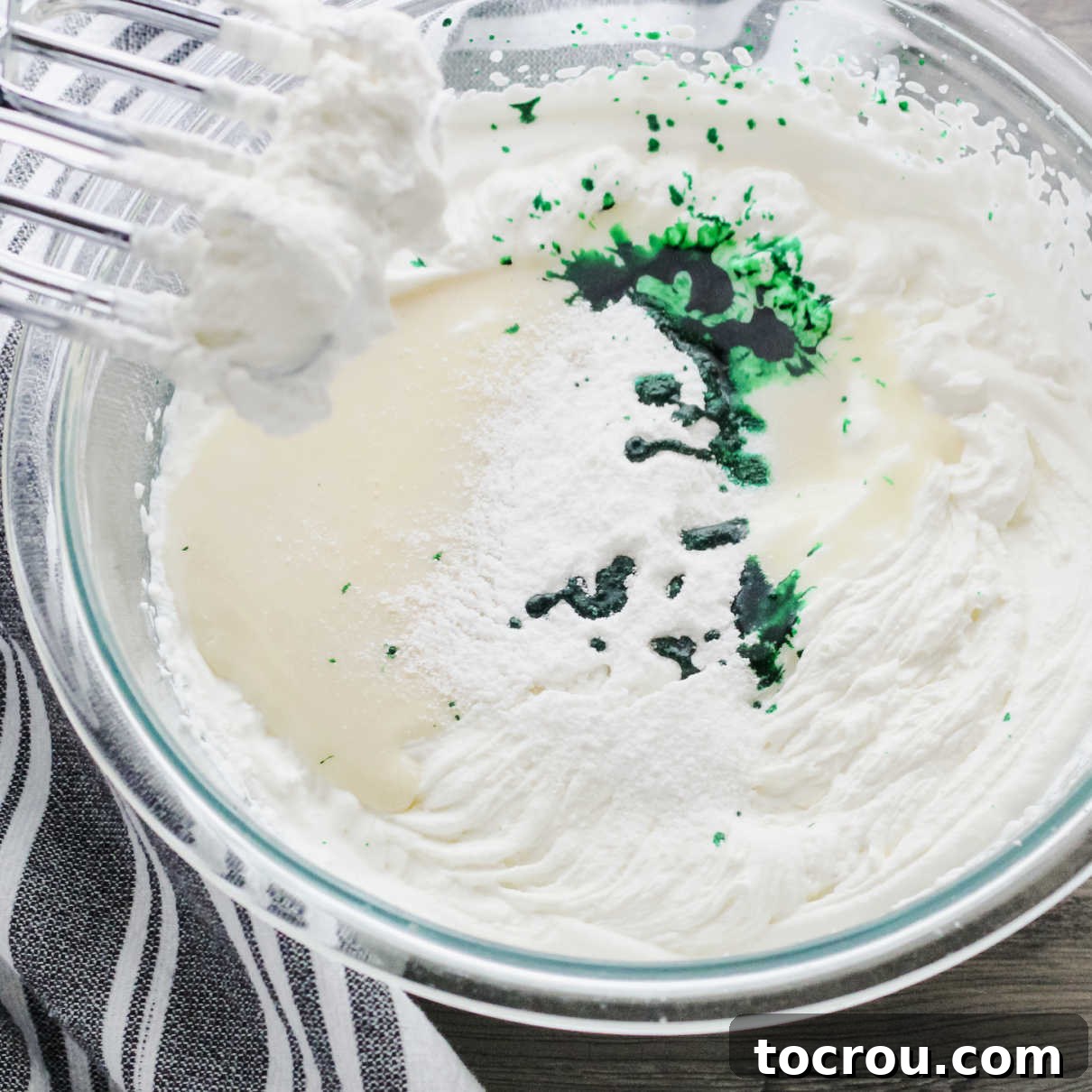 Green Ice Cream Base Bowl of whipped cream and condensed milk with green food coloring ready to be made into ice cream.