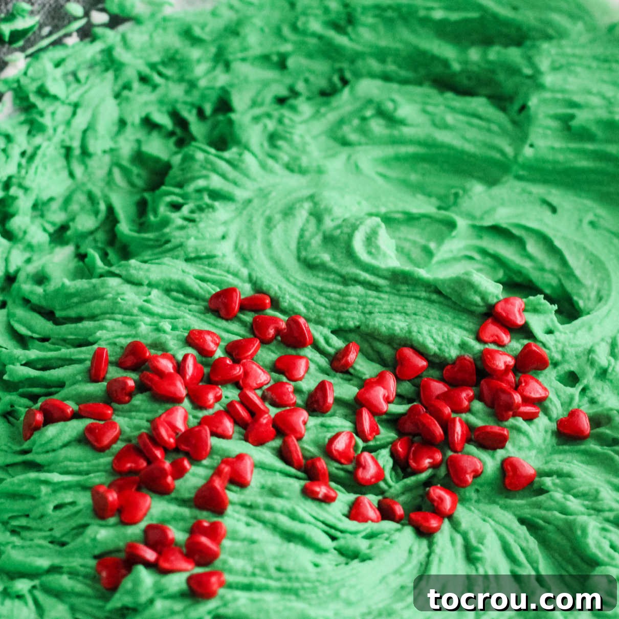 Grinchy Red Candy Hearts red candy hearts sprinkled over green ice cream base.