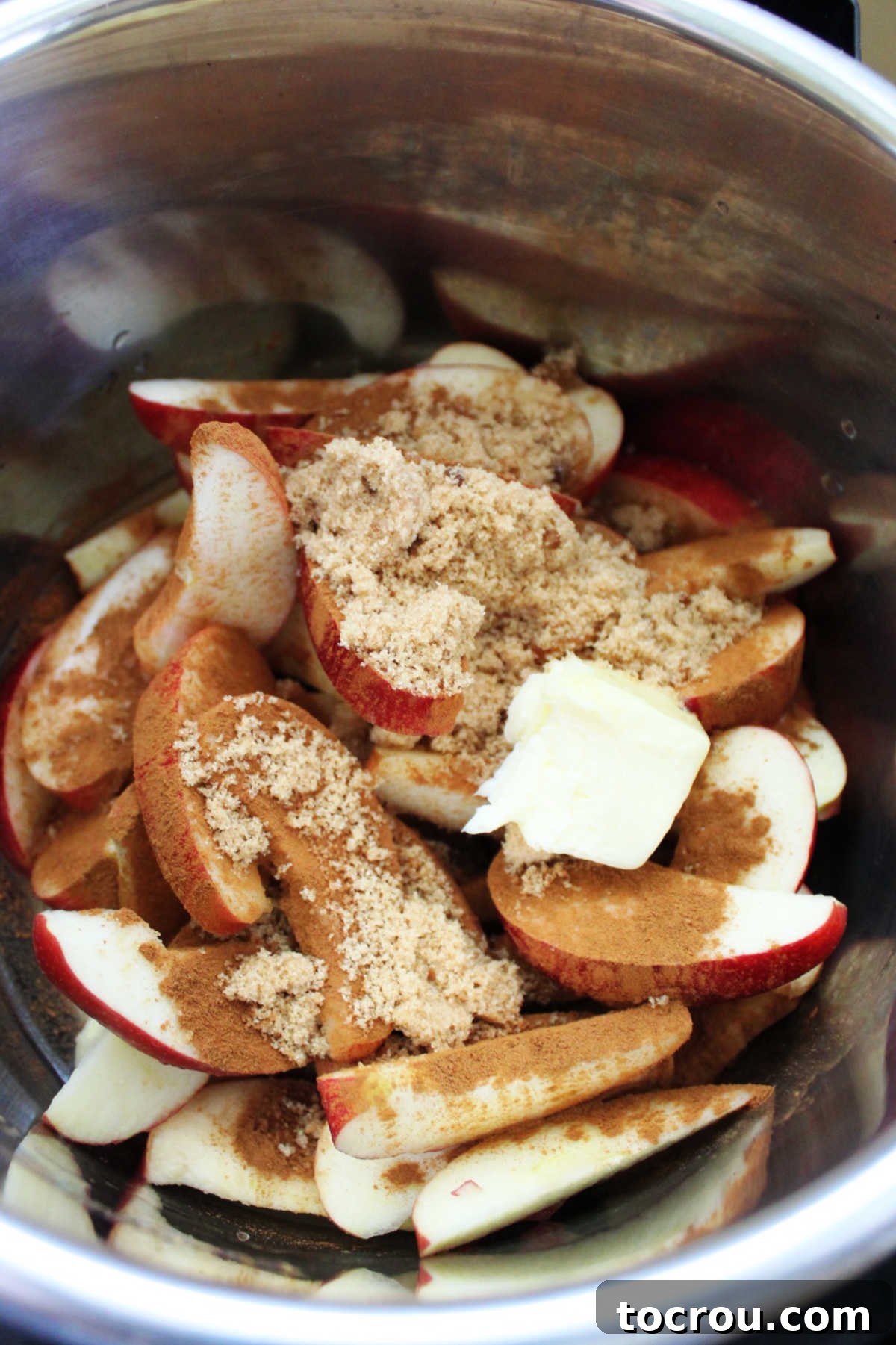 Slices of apples with brown sugar, cinnamon and butter in instant pot.