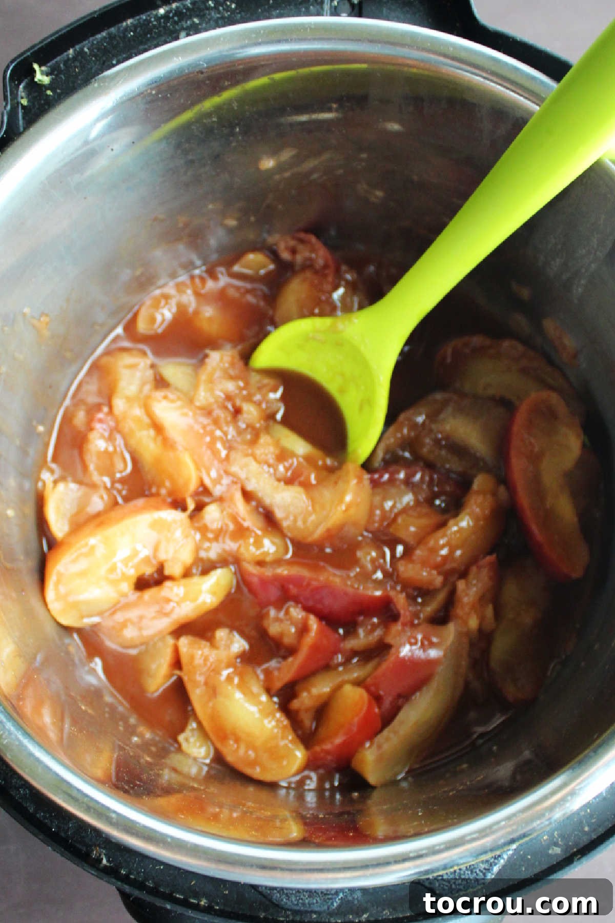 Cooked apples with cinnamon and brown sugar mixture in instant pot.