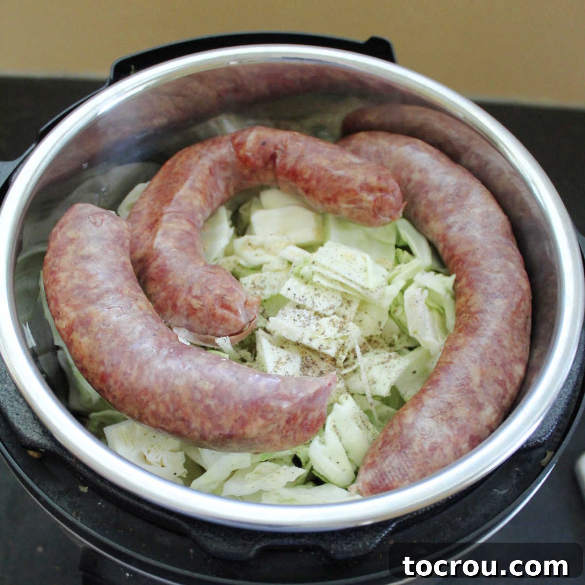 Cabbage, potatoes and sausage in Instant Pot ready to cook.