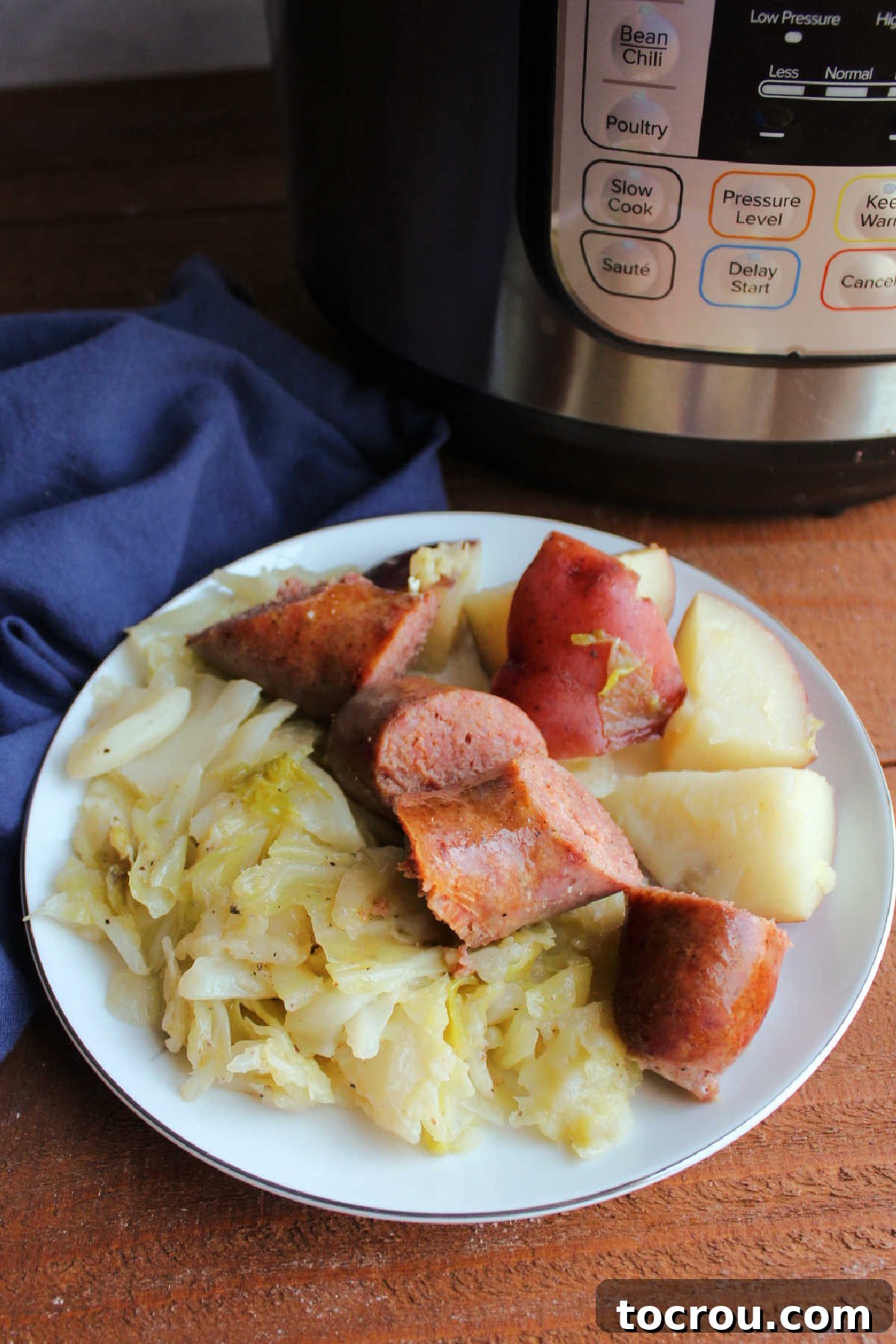 Plate of keilbasa with potatoes and cabbage by instant pot.
