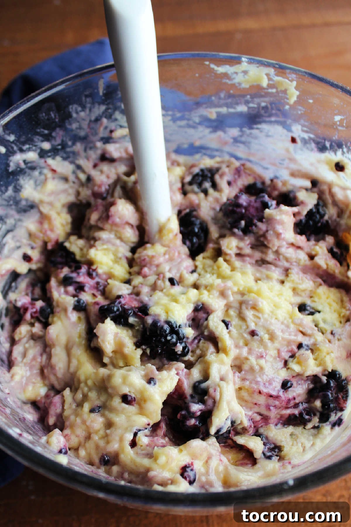 A bowl filled with blackberry sour cream muffin batter, ready for the oven.