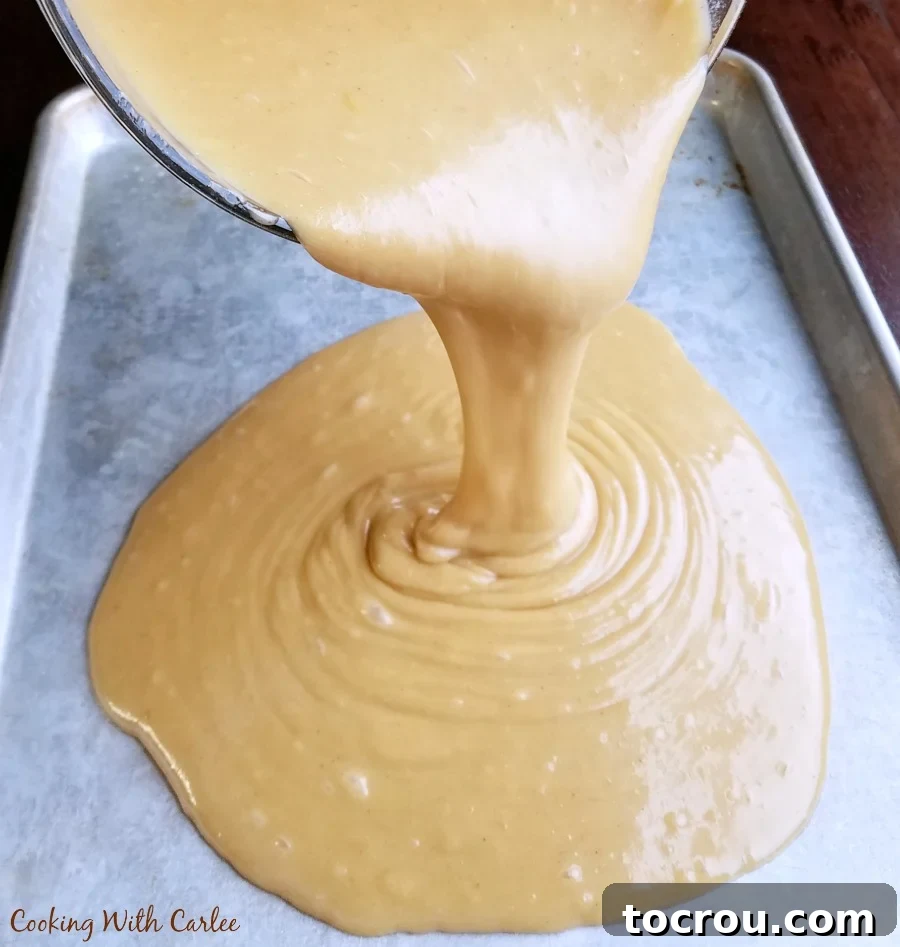 11 Must-Try Texas Sheet Cake Recipes 4 pouring peanut butter cake batter into sheet pan.