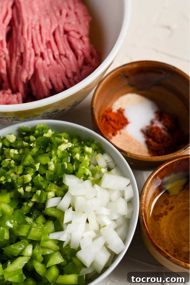 Ingredients for ground turkey burrito filling including the turkey, peppers, onions, and seasonings.