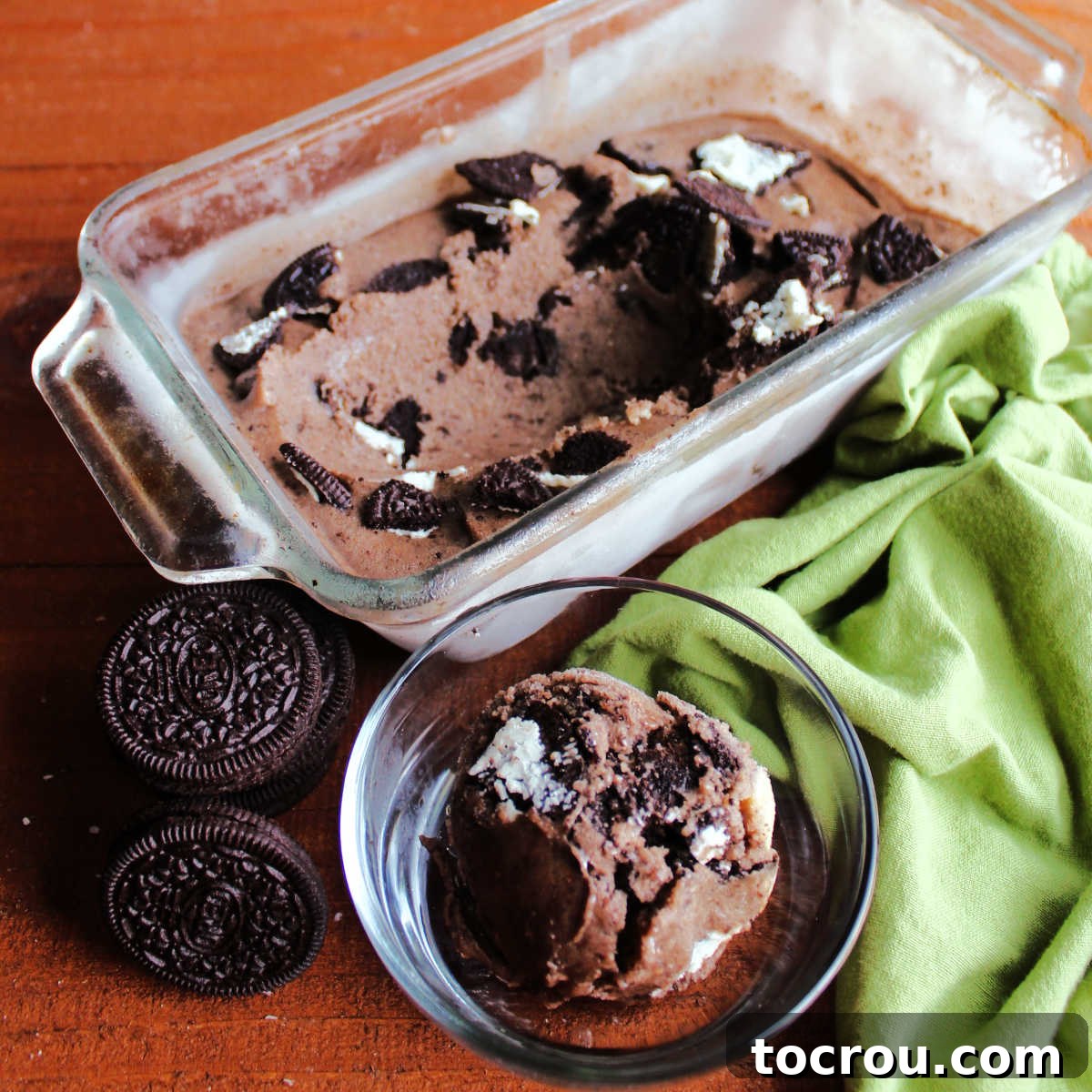 scoop of chocolaty oreo banana nice cream next to loaf pan of ice cream.