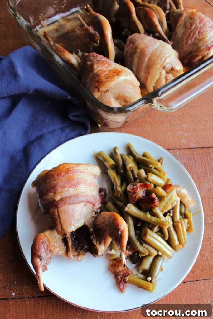 Golden Roasted Bacon Wrapped Quail 3 Bacon wrapped quail on plate with smothered green beans.