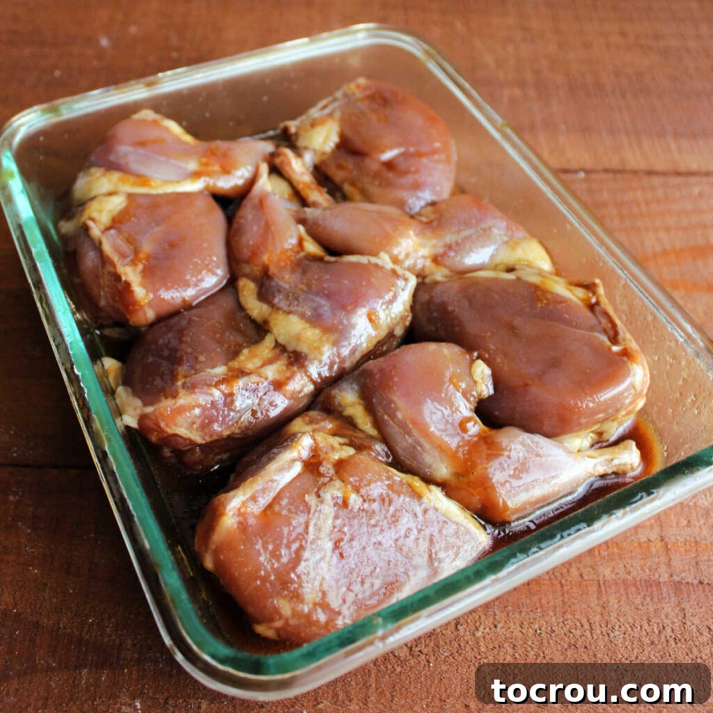 Golden Roasted Bacon Wrapped Quail 5 Quail soaking in soy sauce and brown sugar marinade mixture.