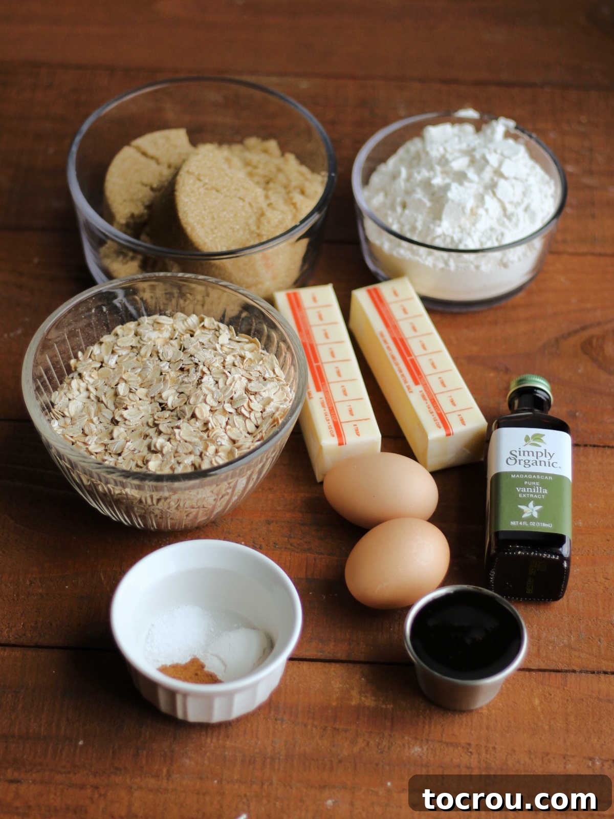Ingredients including butter, brown sugar, flour, oatmeal, eggs, molasses, vanilla, salt, cinnamon, and baking powder ready to be made into oatmeal creme pie bars.